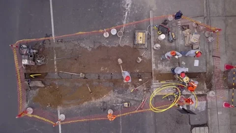 Aerial view with drone from above of workers repairing a gap in the road and the 스톡 동영상 159628299
