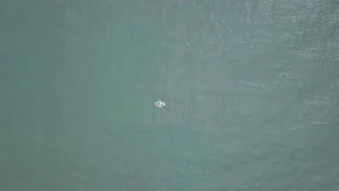 Aerial view with drone approaching a small boat that is fishing in the sea Stock-Footage 143380653