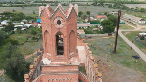 Aerial view on a drone around the bell tower of an old Lutheran Church Stock Footage 164109490