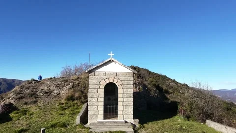 Aerial view from a drone ascending to show the chapel of Monte Teiolo in Genoa Stock Footage 327677953