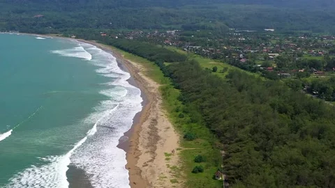 Aerial View Drone Beach waves and green city views are refreshing.Coastal Beach Stock Footage 232034102
