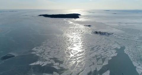 Aerial view, drone coming down. Frozen sea ice, snow and island Video stock 87138955