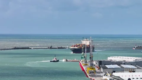 Aerial view by drone of a container ship in Le Havre seaport 01 Видео 330669357
