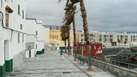 Aerial view - drone flies over a girl who walks along an antique tile during a Stock Footage 112353998