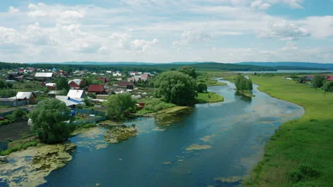 Aerial view. Drone flies over river in village in sunny summer day Stock Footage 138003879
