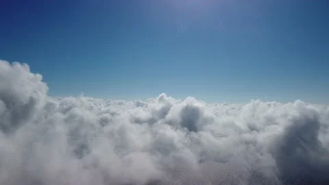 Aerial view. The drone flies over foggy and fluffy clouds. Blue sky sun and sea Stock Footage 165436235