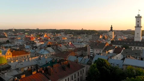 Aerial view drone flight above the roofs on sunset Video stock 107994409