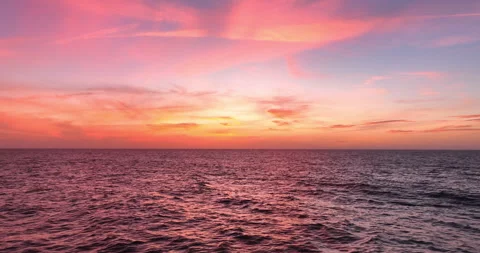 Aerial view of drone flight over the ocean during sunset, water surface in the Stock Footage 254190527