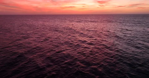 Aerial view of drone flight over the ocean during sunset, water surface in the Stock Footage 286199142