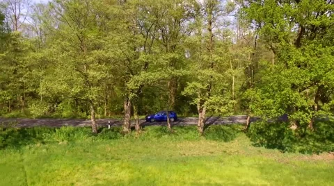 Aerial view drone fly - a car drive on a road in germany Stock Footage 62929881