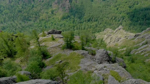 Aerial View, Drone Fly over the seated girl on a cliff face 動画素材 92056598