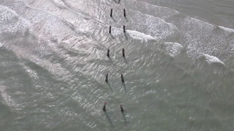 Aerial view of drone fly over the cement pillar from sea side to land or beach Stock Footage 153392667