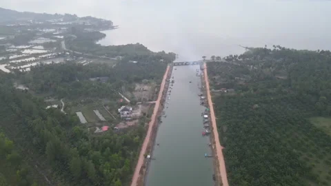 Aerial view of drone fly over manmade big river go from village Stock-Footage 153404744
