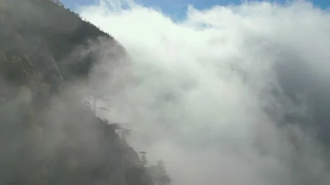Aerial view, drone fly through clouds on mountains. Stock Footage 232273030