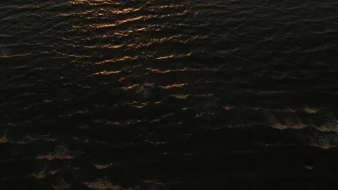 Aerial view drone flying above the sea surface with orange reflections of sunset Stock-Footage 165059384