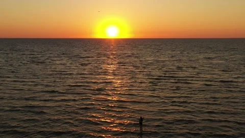 Aerial view drone flying above the sea surface with orange reflections of sunset Stock-Footage 165300646
