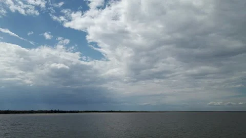Aerial view from a drone flying above a large lake with a shore Stock Footage 276123933