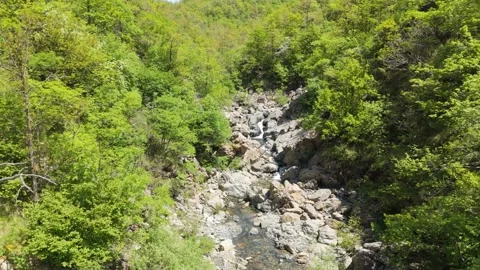 Aerial view from a drone flying backward over the Stura River in Liguria, Italy Video stock 335236768