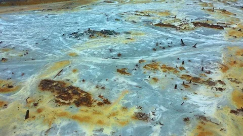 Aerial view; drone flying forward over a polluted river with destroyed ecosystem Stock Footage 118265612