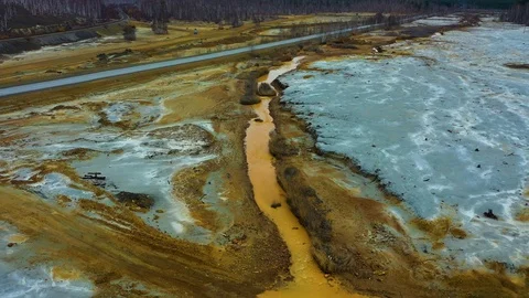 Aerial view; drone flying forward over a polluted river with destroyed ecosystem Stock Footage 118266607