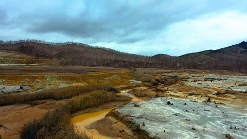 Aerial view; drone flying forward over a polluted river with destroyed ecosystem Stock Footage 118281303