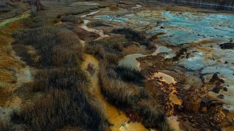 Aerial view; drone flying forward over a polluted river with destroyed ecosystem Stock Footage 118281668