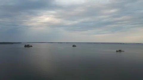 Aerial view from a drone flying forward over a large northern lake  Stock Footage 276281003