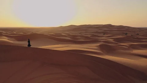 Aerial view from a drone flying next to a woman in abaya United Arab Emirates Stock Footage 109438059