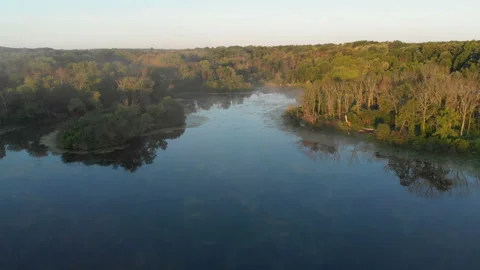 Aerial view, drone flying over water, mist, forest at sunrise Vídeo Stock 113447892