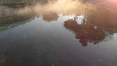 Aerial view, drone flying over water, mist, forest at sunrise Vidéo 113491722