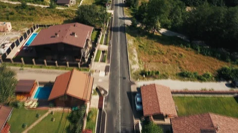 Aerial view; drone flying over streets of mountain village Stock Footage 117430896