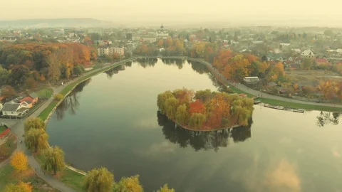Aerial view of drone flying over a beautiful lake with an island , Kolomyia Stock Footage 118248922