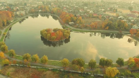 Aerial view of drone flying over a beautiful lake with an island , Kolomyia Stock Footage