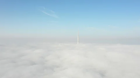 Aerial view from a drone flying over fog towards Dubai Downtown. Stock Footage 118261576