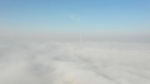 Aerial view from a drone flying over fog towards Dubai Downtown. Stock Footage 118261615