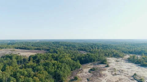 Aerial View of Drone Flying Over Desolate Wasteland Mountain With Green Trees Stock Footage 130866734
