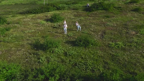 Aerial view from drone flying over of a group of European women in exotic Stock Footage 150933352