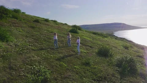 Aerial view from drone flying over of a group of European women in exotic Stock Footage 151033014