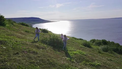 Aerial view from drone flying over of a three of European women in exotic Stock Footage 151044672