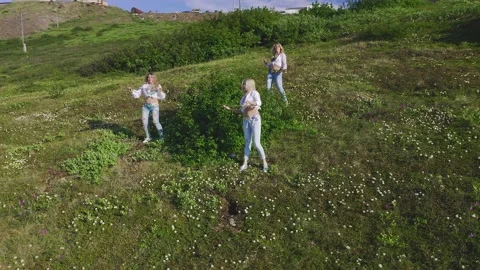 Aerial view from drone flying over of a three of European women in exotic Stock Footage 151044843