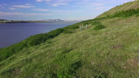Aerial view from drone flying over of a three of European women in exotic Stock Footage 151044896