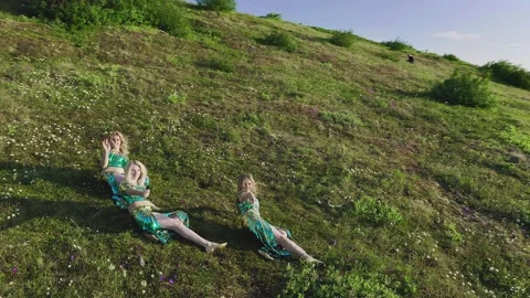 Aerial view of a drone flying over three European women in exotic oriental Stock Footage 151075431
