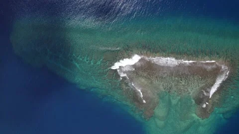 Aerial view of a drone flying over a calm ocean with a coral reef Stock Footage 163119043