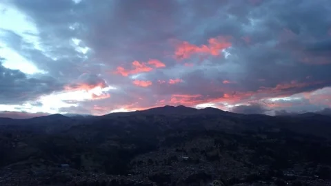 Aerial view from drone flying over the city of Huaras in an orange sunset over Stock Footage 164579661