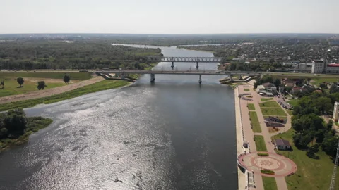 Aerial view from a drone flying over a river in a city with a view of bridges.  Stock Footage 169499665
