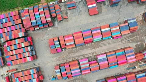 Aerial view from a drone flying over a many cargo containers Video stock 210786376