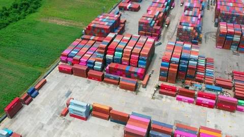 Aerial view from a drone flying over a many cargo containers Video stock 210788034
