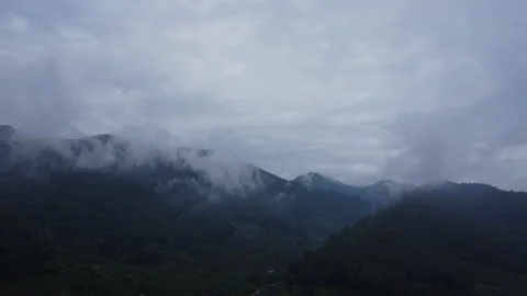 Aerial view from a drone flying over a foggy rural village in winter. Stock Footage 222455901