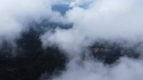 Aerial view from a drone flying over a foggy rural village in winter. 動画素材 222460455