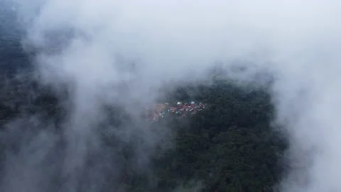 Aerial view from a drone flying over a foggy rural village in winter. 動画素材 222463169